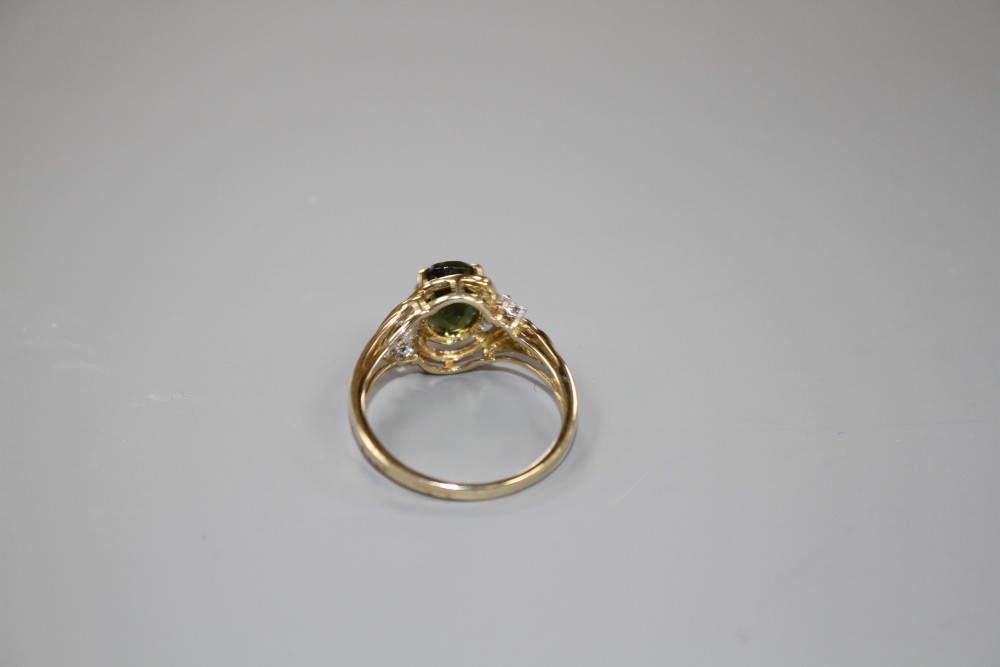 A modern 9ct gold, olive green paste and diamond set dress ring, size S, gross weight 3.2 grams.